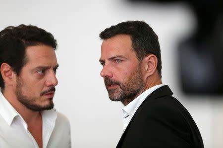 Former trader Jerome Kerviel (R) and his lawyer David Koubbi (L) stand inside the courthouse in Versailles, France, September 23, 2016. REUTERS/Charles Platiau