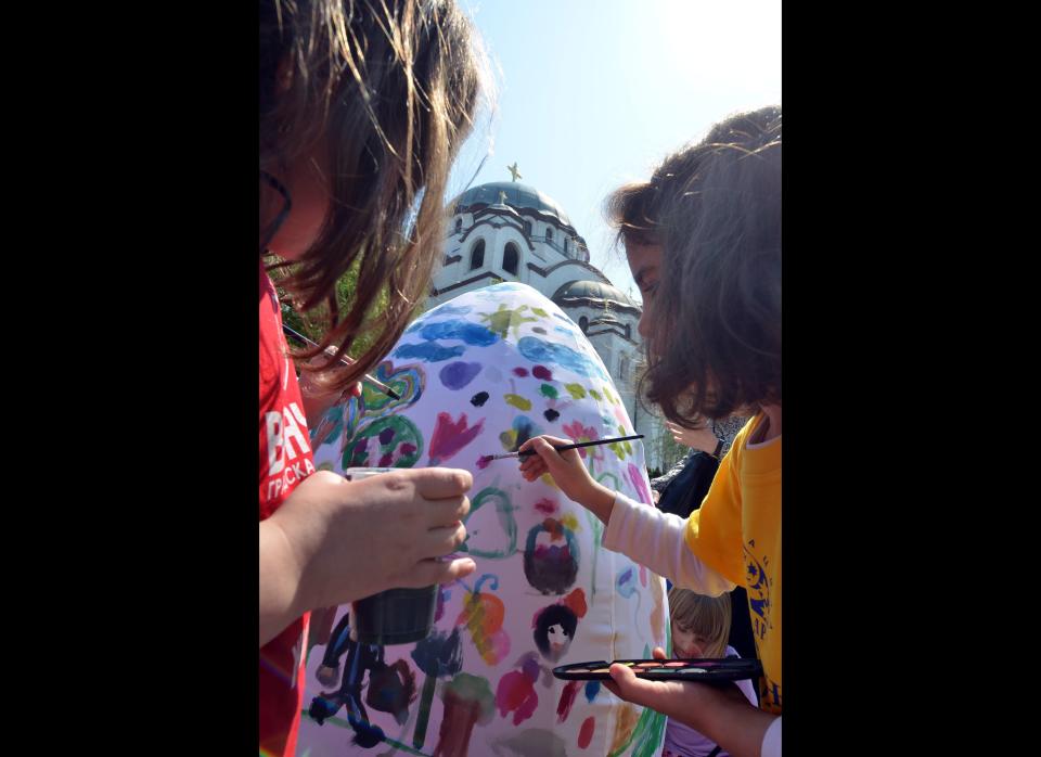 Girls paint a giant Easter egg on April 21, 2011, in Belgrade. Traditionally Orthodox Serbs observe Easter according to the old Julian calendar, which this year falls April 24. AFP PHOTO / ANDREJ ISAKOVIC (Photo credit should read ANDREJ ISAKOVIC/AFP/Getty Images)