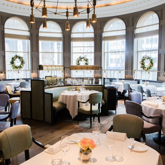 The floor-to-ceiling bay windows at the Roux at the Landaux show off quintessential London life below. Photo: Roux at the Landaux Instagram