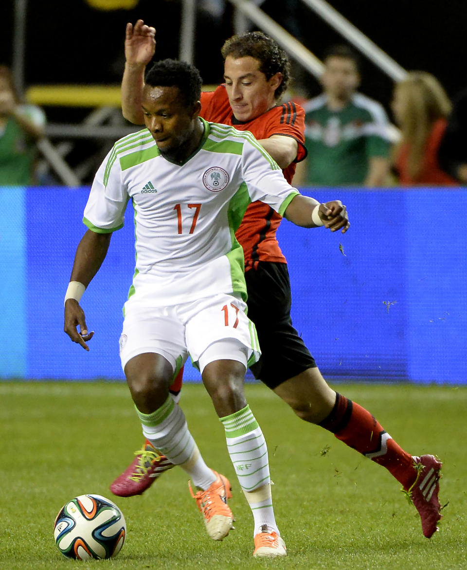 Nigeria's Ogenyi Onazi (17) controls the ball in front of Mexico's Andres Guardado during the first half of an international friendly soccer match Wednesday, March 5, 2014, in Atlanta. (AP Photo/David Tulis)