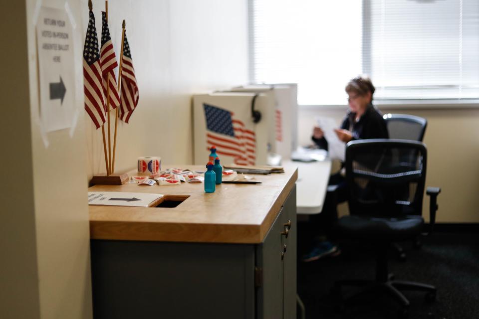 Flags and a sign show where to drop your ballet off at the Polk County Auditor’s Office in downtown Des Moines on Wednesday, Oct. 19, 2022. Today was the first day of early voting in the 2022 election for Polk County voters.