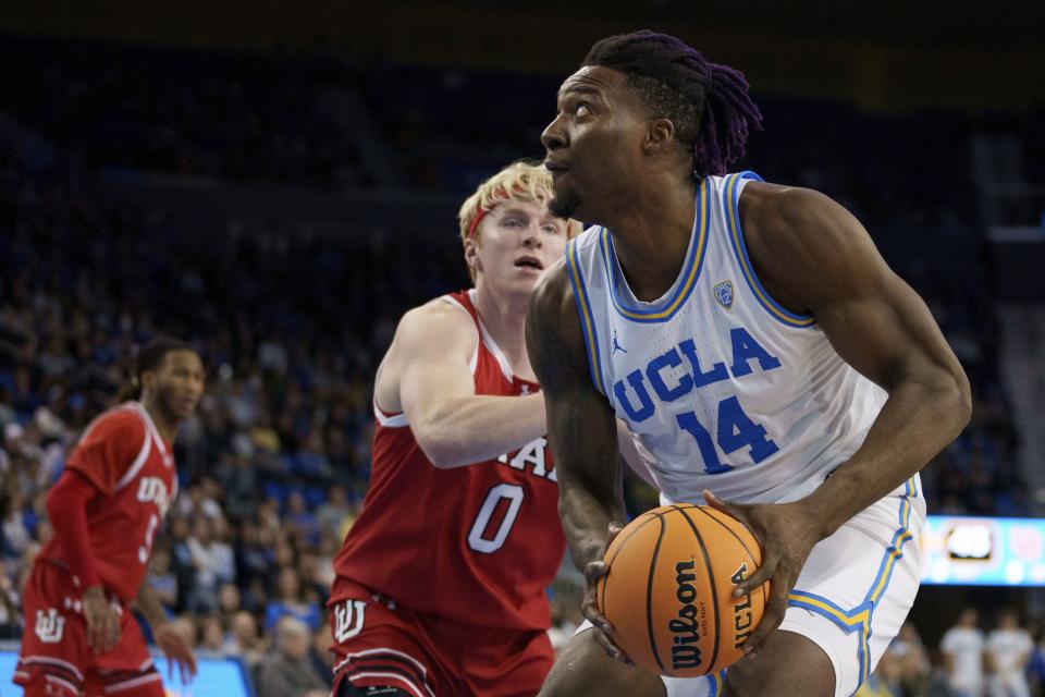 UCLA forward Kenneth Nwuba (14) goes to the basket against Utah guard Hunter Erickson (0) during the second half of an NCAA college basketball game, Sunday, Feb. 18, 2024, in Los Angeles. | Eric Thayer, AP