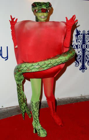 <p>Jon Kopaloff/FilmMagic</p> Heidi Klum dressed as a forbidden apple her at annual Halloween party in 2006