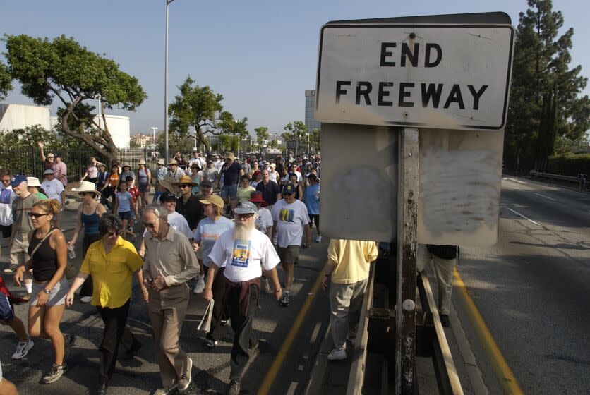 06/15/2003: Pedestrians walk on the 110 Pasadena Freeway as part of the Arroyo Fest, Sunday, June 15, 2003, in Pasadena, Calif. The freeway, the first of its kind in the U.S. which was opened in 1944, was shut down for several hours so that residents could take the time to appreciate the historic Arroyo Seco canyon. KEYWORDS: CALIFORNIA. HISTORY. STREETS AND ROADS (AP Photo/Joe Cavaretta)