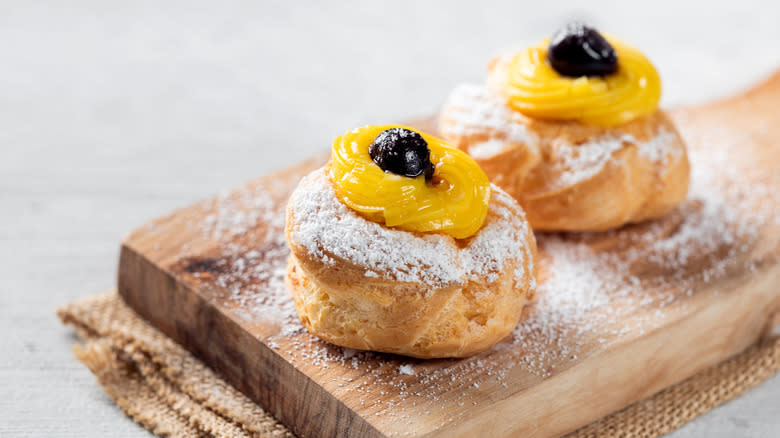 Zeppole with custard and black cherries