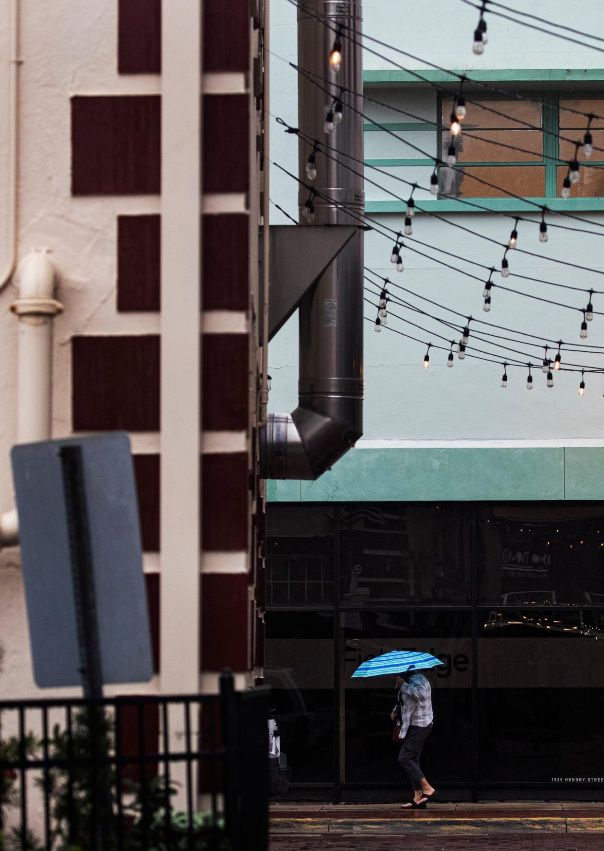 A light rain fall downtown Fort Myers on Friday, March 22, 2024. A system is moving through southern Florida and is dropping copious amounts of precipitation on the state.