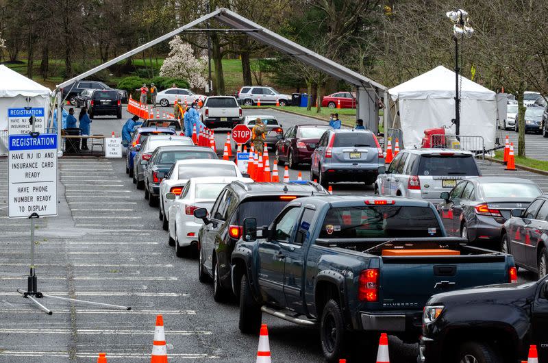 Cars form lines at a federally-supported drive-thru testing site in Holmdel