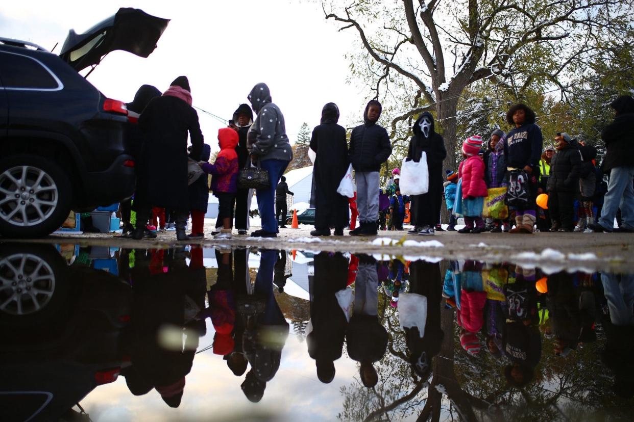 Trick-or-treaters lineup for Halloween candy on Thursday, Oct. 31, 2019, at Andrews Park in Rockford. [SCOTT P. YATES/RRSTAR.COM STAFF]