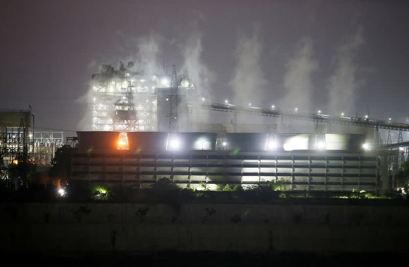 FILE PHOTO: Smoke billows from the cooling towers of a coal-fired power plant in Ahmedabad