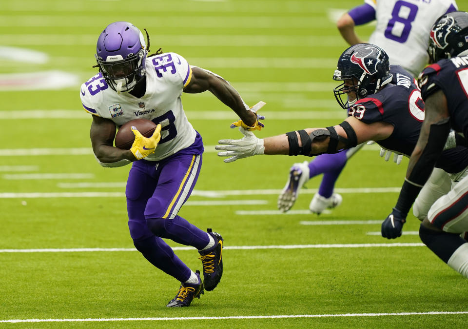 Minnesota Vikings running back Dalvin Cook (33) breaks away from Houston Texans defensive end J.J. Watt (99) during the second half of an NFL football game Sunday, Oct. 4, 2020, in Houston. (AP Photo/David J. Phillip)