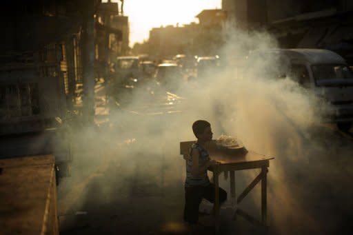 A Syrian boy waits for customers at a roadside stall set up just in time for the iftar meal with which Muslims break their fast during the fasting month of Ramadan in the town of Azaz, north of Aleppo, on August 11. The battle for Syria is raging on the ground but also on social media, where people on both sides of the conflict are hacking, posting and spamming in a frenzied propaganda war