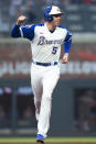 Atlanta Braves' Freddie Freeman celebrates a two-run home run by Austin Riley against the Milwaukee Brewers during the first inning of a baseball game Friday, July 30, 2021, in Atlanta. (AP Photo/Hakim Wright Sr.)