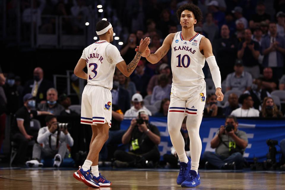 Jalen Wilson and Dajuan Harris Jr. react in the second half of the game against the Creighton Bluejays during the second round of the 2022 NCAA Tournament.