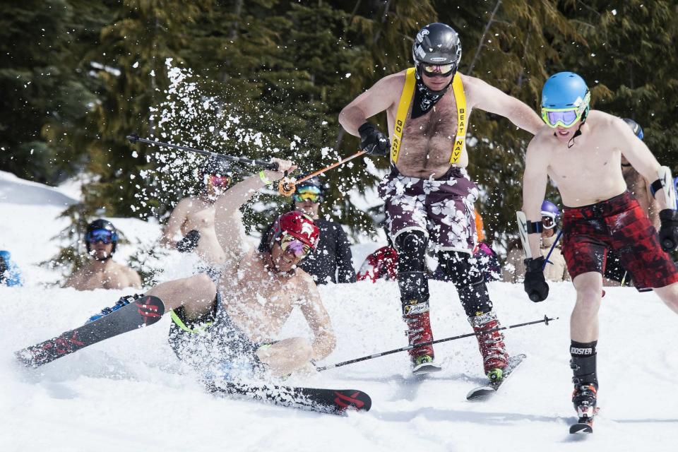 A skier crashes during the Bikini & Board Shorts Downhill at Crystal Mountain, a ski resort near Enumclaw, Washington April 19, 2014. Skiers and snowboarders competed for a chance to win one of four season's passes. REUTERS/David Ryder (UNITED STATES - Tags: SPORT SKIING SNOWBOARDING SOCIETY)