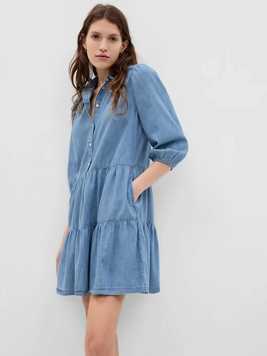 model wears blue Puff Sleeve Denim Mini Shirtdress with Washwell. Image via Gap.