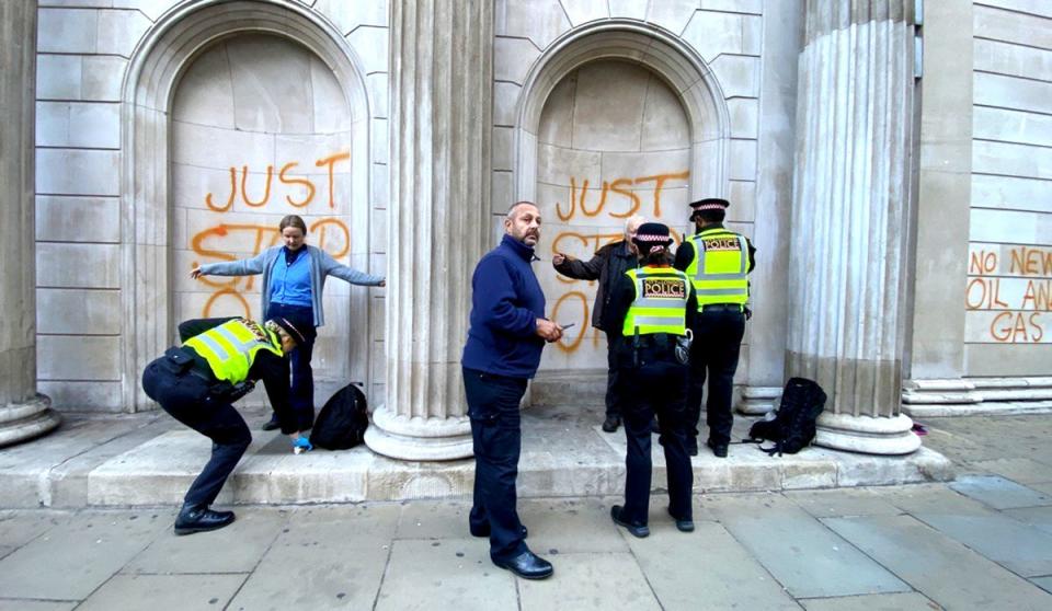 Protesters sprayed orange paint on a number of buildings in London on Monday (PA)