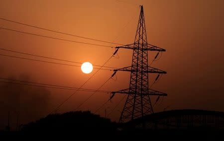 The sun sets behind a power transmission line in Rawalpindi, Pakistan, October 3, 2016. Picture taken October 3, 2016. REUTERS/Faisal Mahmood