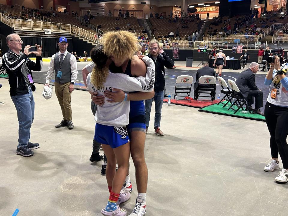 Matanzas' Mariah Mills hugs older brother Jordan Mills after Jordan won the 2A state championship at 190 pounds, Saturday, March 2, 2024, at Silver Spurs Arena in Kissimmee. Mariah also claimed an individual state title at 110 pounds.