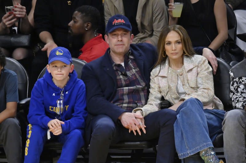 Jennifer Lopez (R), Ben Affleck (C) and his son Samuel Garner Affleck attend a Los Angeles Lakers and Golden State Warriors basketball game in March. File Photo by Jim Ruymen/UPI