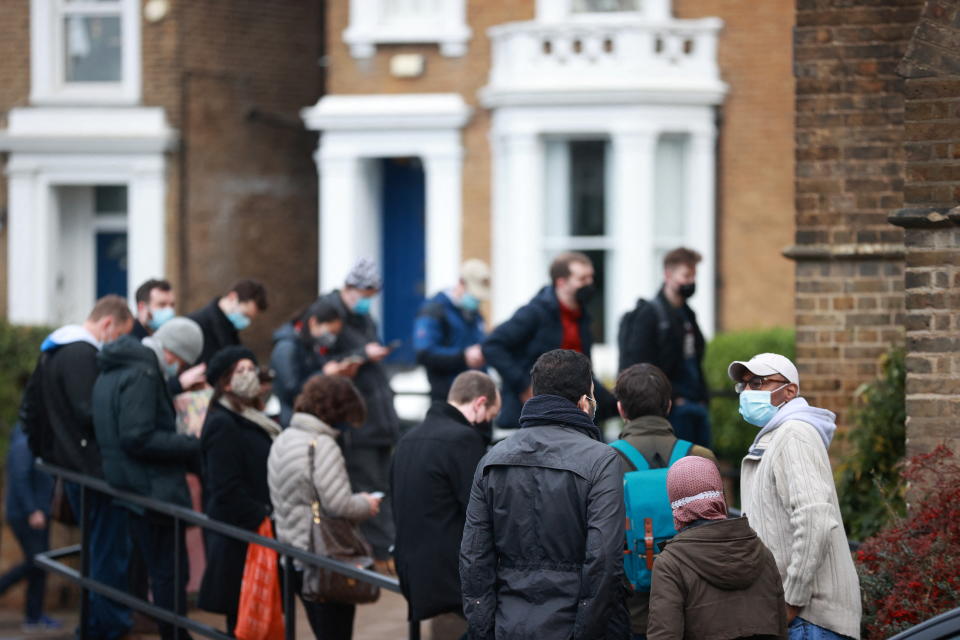 People queue outside a coronavirus disease (COVID-19) vaccination centre at a church in London, Britain, December 13, 2021. REUTERS/Hannah McKay