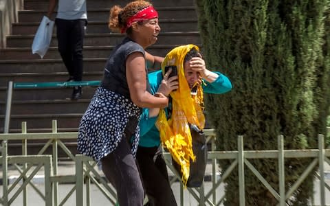 Family members of the victims involved in a plane crash react at Addis Ababa international airport  - Credit: AP