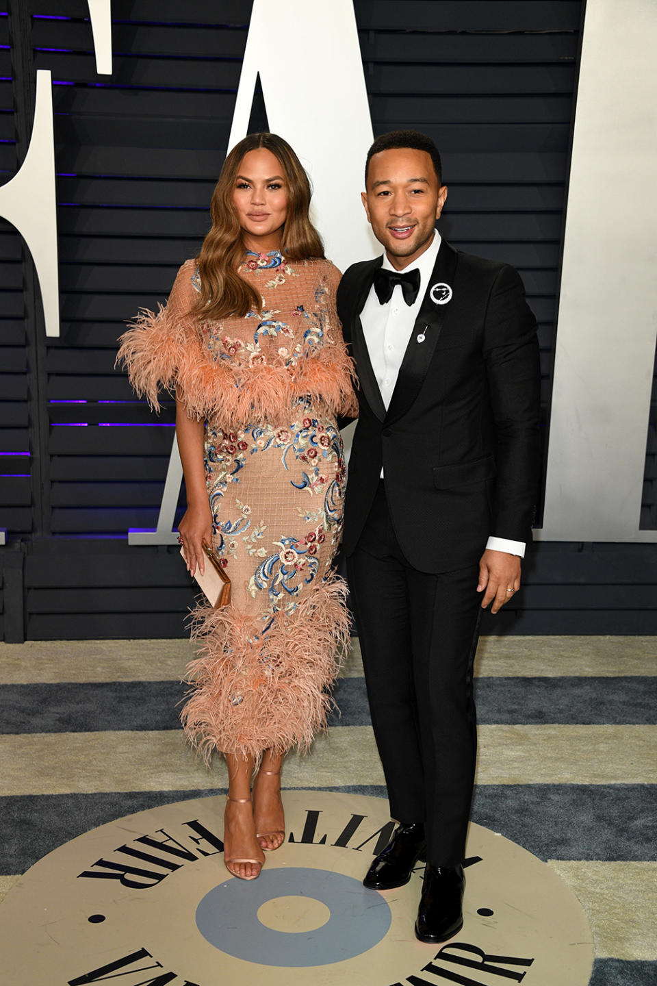 <p>Chrissy is wearing a Marchesa dress from the label’s pre-Autumn 2019 collection, while John is wearing a Gucci tuxedo. <em>[Photo: Getty]</em> </p>