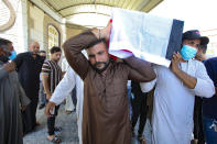 Mourners carry the flag-draped coffin of activist Reham Yacoub during her funeral procession in Basra, Iraq, Thursday, Aug. 20, 2020. Activist Reham Yacoub was gunned down in the southern Iraqi province of Basra on Wednesday by unidentified gunmen, a security official and human rights watcher said, marking the second such killing in the span of a week. The official spoke on condition of anonymity in line with regulations. (AP Photo/Nabil al-Jurani)