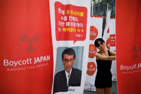 FILE PHOTO: A South Korean woman attends an anti-Japan rally near the Japanese embassy in Seoul