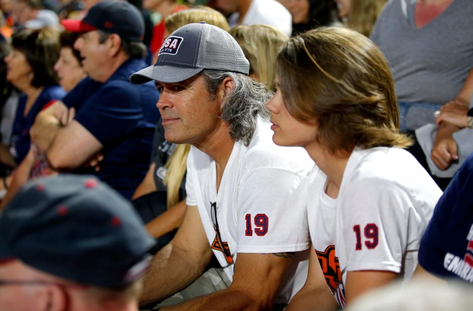 Casey Elish, left, and Brady Elish watch a Women's College World Series softball game between the Oklahoma State University Cowgirls and the University of Arizona Wildcats at USA Softball Hall of Fame Stadium in Oklahoma City, Thursday, June, 2, 2022. 