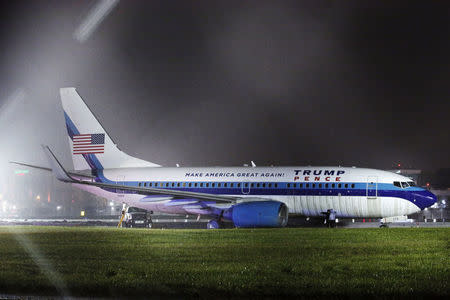 Men inspect a campaign plane that had been carrying U.S. Republican vice presidential nominee Mike Pence after it skidded off the runway while landing in the rain at LaGuardia Airport in New York, U.S.,October 27, 2016. REUTERS/Lucas Jackson