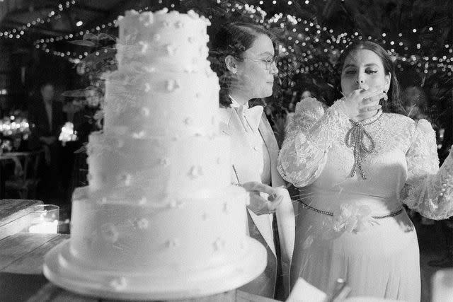 <p>Corbin Gurkin </p> Beanie Feldstein and Bonnie-Chance Roberts eating cake at their wedding