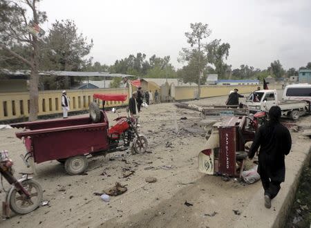 Residents of the area look at the scene of a suicide bomb attack in Khost province, April 2, 2015. REUTERS/Anwarullah