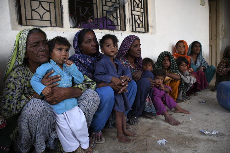 Women and children take shelter in a school building after fleeing from their villages due to Cyclone Biparjoy approaching, at a costal area of Badin district, in Pakistan's Sindh province, Tuesday, June 13, 2023. Pakistan's army and civil authorities are planning to evacuate 80,000 people to safety along the country's southern coast, and thousands in neighboring India sought shelter ahead of Cyclone Biparjoy, officials said. (AP Photo/Umair Rajput)