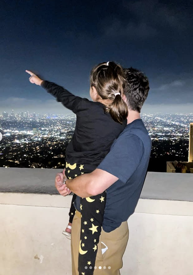 Image: B.J. Novak holds Mindy Kaling's daughter, Katherine at the Griffith Observatory. (@mindykaling / via Instagram)