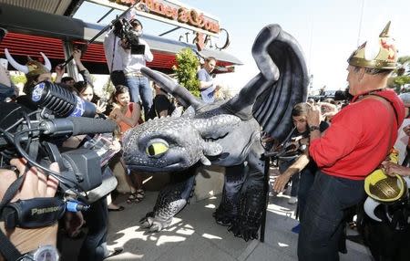 A figure of Toothless the Dragon character walks on the Croisette during a photocall for the film "How to Train Your Dragon 2" at the 67th Cannes Film Festival in Cannes May 15, 2014. REUTERS/Regis Duvignau
