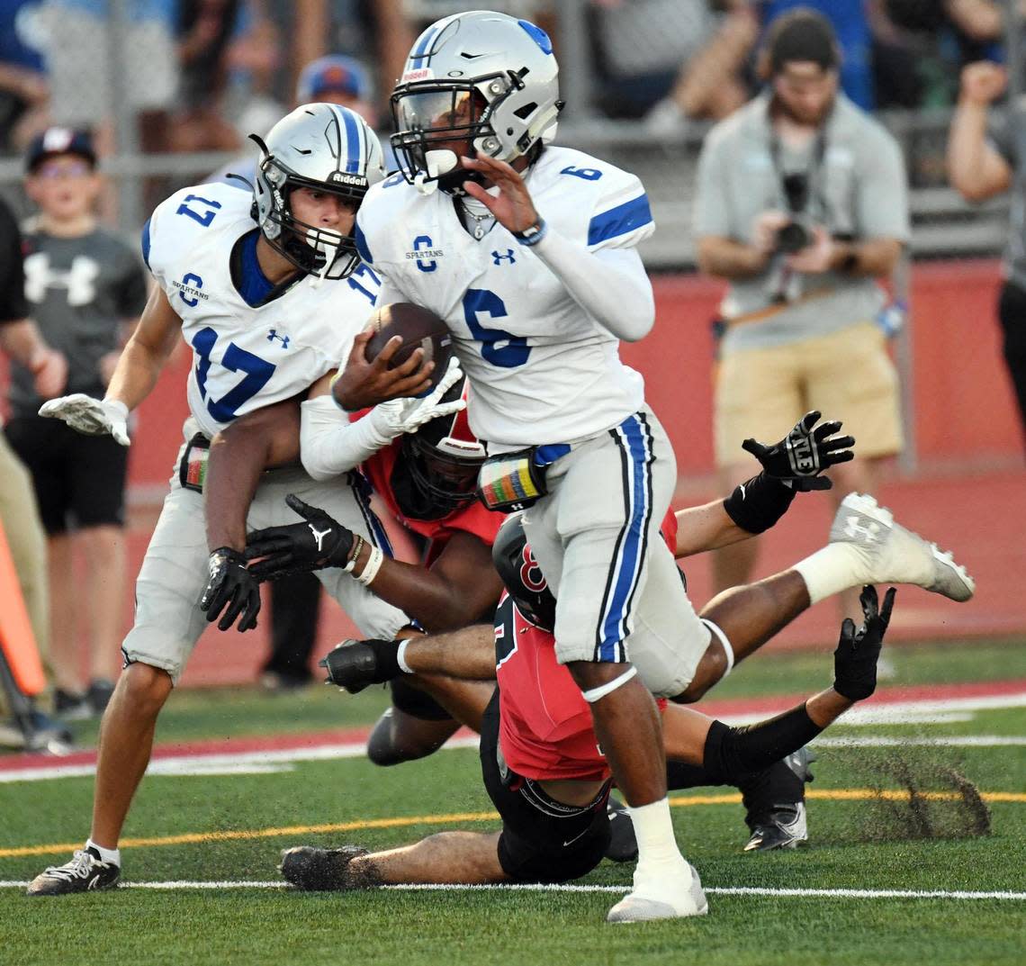 Centenial Quarterback Phillip Hamilton, center escapes Burleson’s Kalun Blair as he scrambles for a touchdown to take a 1`4-0 lead in the first quarter during Friday’s, August 26, 2022 football game at Elk Stadium in Burleson, Texas. Special/Bob Haynes