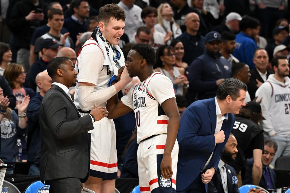Connecticut center Donovan Clingan (32) reacts with guard Hassan Diarra (10) during the championship game of the East Regional of the 2024 NCAA men's tournament at TD Garden.