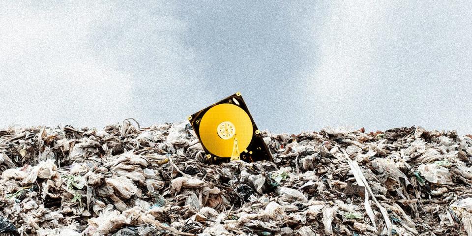 A shimmering hard drive in a landfill