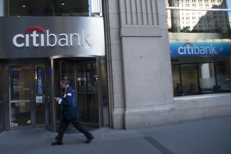 Passersby walk in front of a Citibank branch in New York, October 16, 2012. REUTERS/Keith Bedford