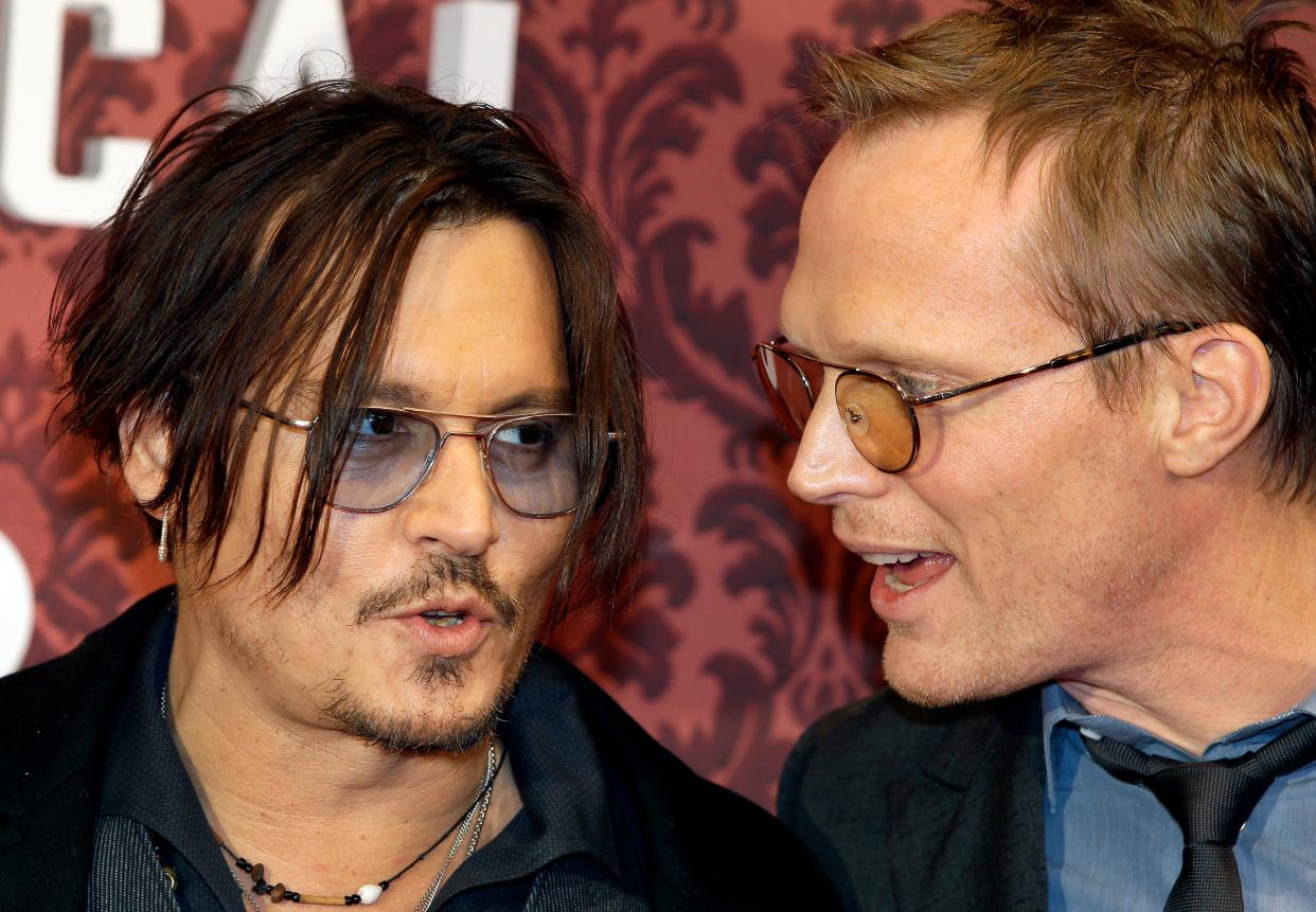US actor Johnny Depp, left, and British actor Paul Bettany, right, talk as they arrive for the world premiere of the movie 'Mortdecai' in Berlin, Germany, Sunday, Jan. 18, 2015.