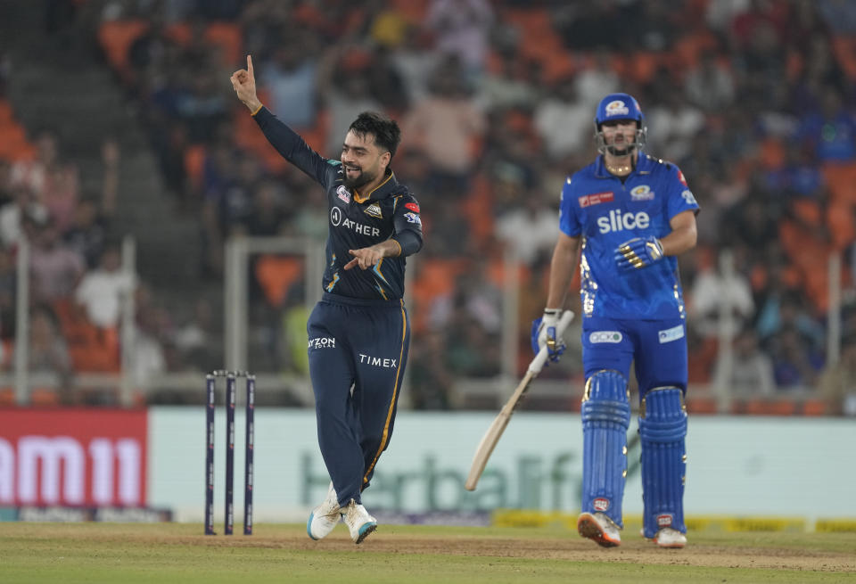 Gujrat Titans' Rashid Khan successfully appeals for the wicket of Mumbai Indians' Tim David during the Indian Premier League qualifier cricket match between Gujarat Titans and Mumbai Indians in Ahmedabad, India, Friday, May 26, 2023. (AP Photo/Ajit Solanki)