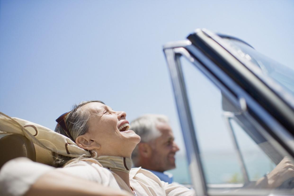 Mature couple driving in convertible