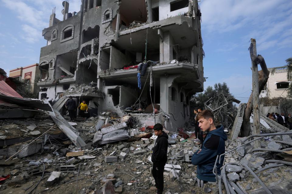 Palestinians inspect the rubble of a building destroyed in an Israeli strike in Maghazi refugee camp, central Gaza Strip, on Dec. 25, 2023.