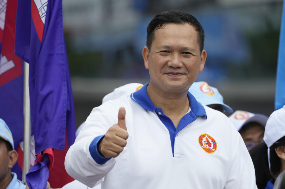 Hun Manet, a son of Cambodia Prime Minister Hun Sen, shows a thumbs-up as he leads a procession to mark the end of an election campaign of Cambodian People's Party, in Phnom Penh, Cambodia, Friday, July 21, 2023. Hun Sen says he is ready to hand the premiership to his oldest son, Hun Manet, who heads the country’s army. (AP Photo/Heng Sinith)