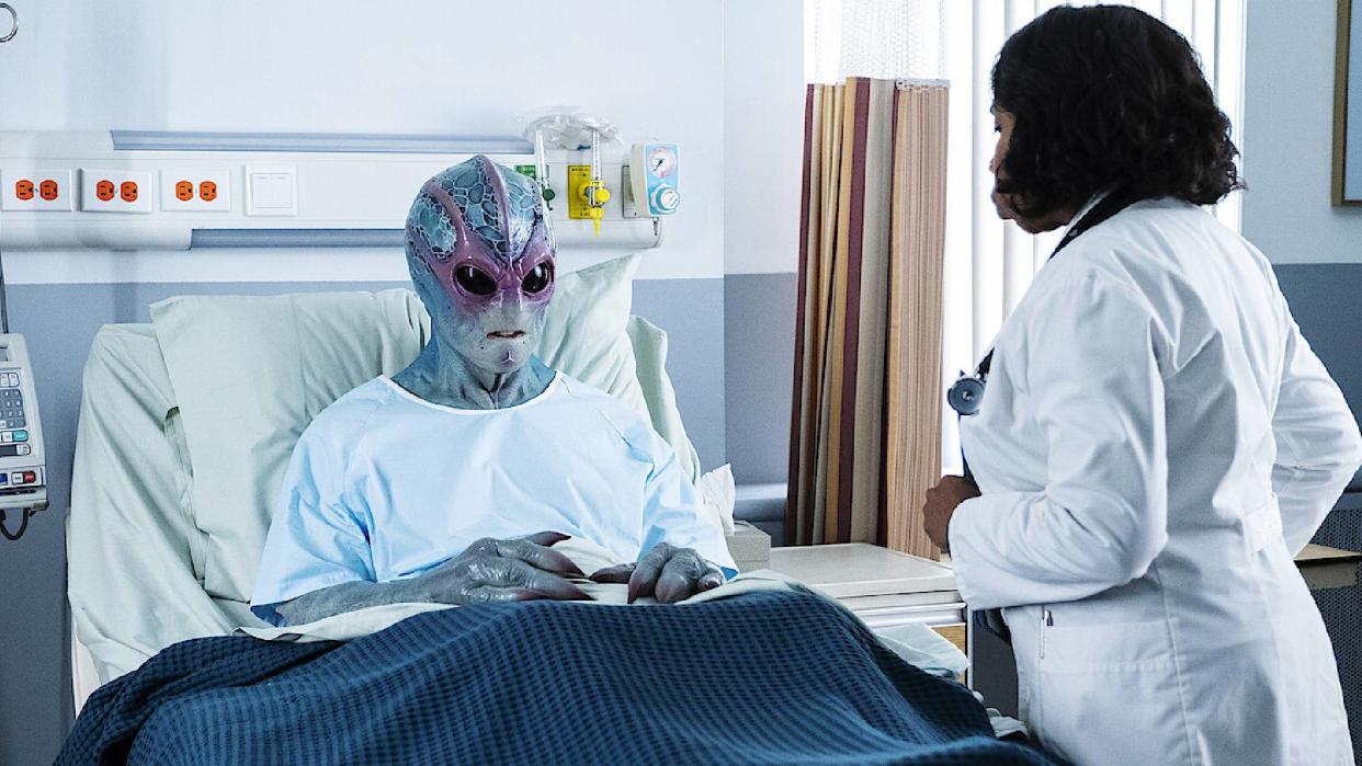  Resident Alien image showing Harry Vanderspeigle in a hospital bed. 