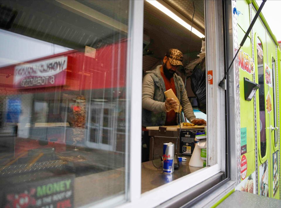 Ahmed Aldoori, an Iraqi immigrant and owner of the new Heisenberg Mediterranean food truck, prepares a meal on Friday, Nov. 12, 2021, at a location in Clive. Aldoori has been working with Catholic Charities and USCRI to provide hot meals to Afghan evacuees when they arrive to Des Moines. 