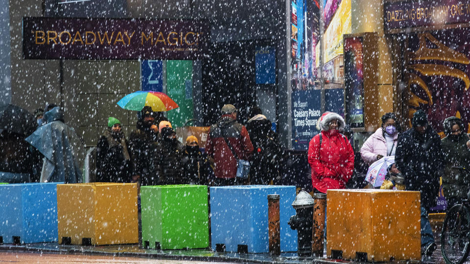 People make their way around Times Square during a winter storm in New York, Sunday, Jan. 7, 2024. (AP Photo/Eduardo Munoz Alvarez)