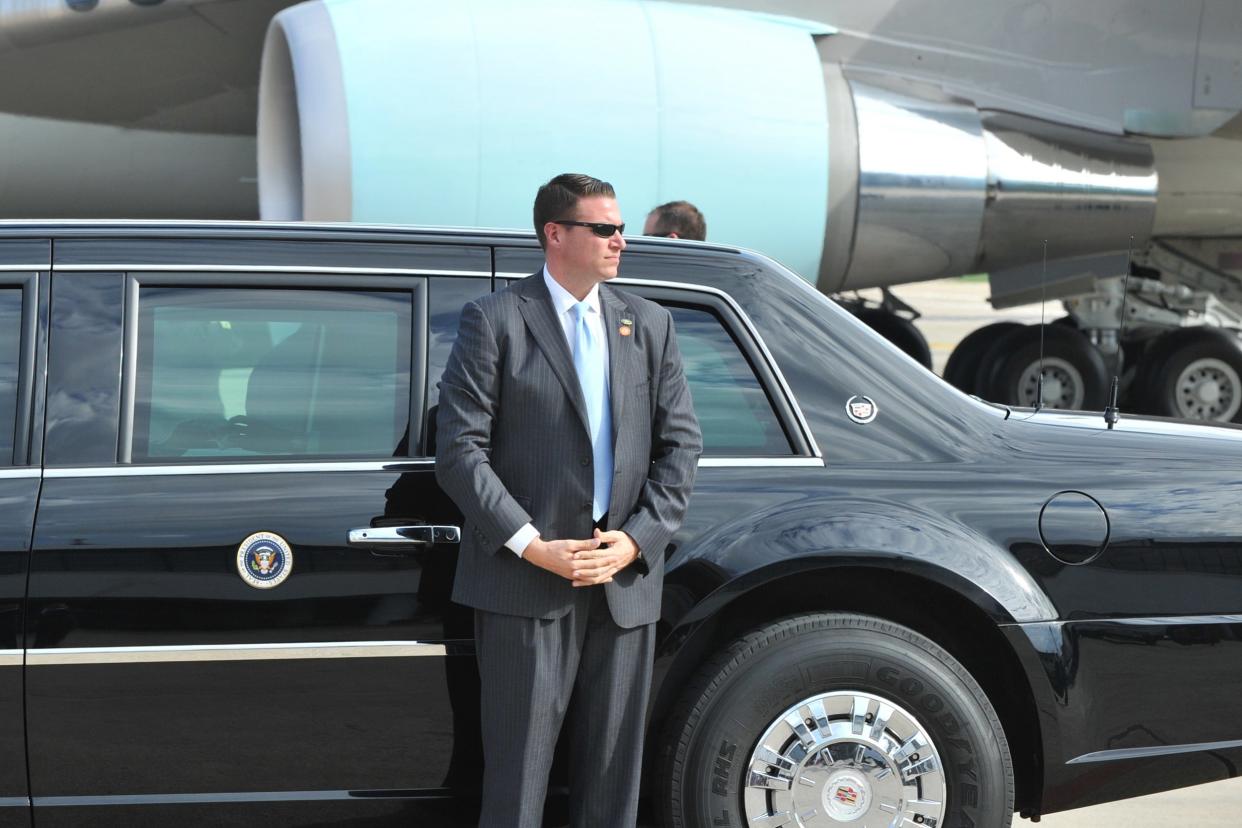 Secret Service agent standing in front of limo