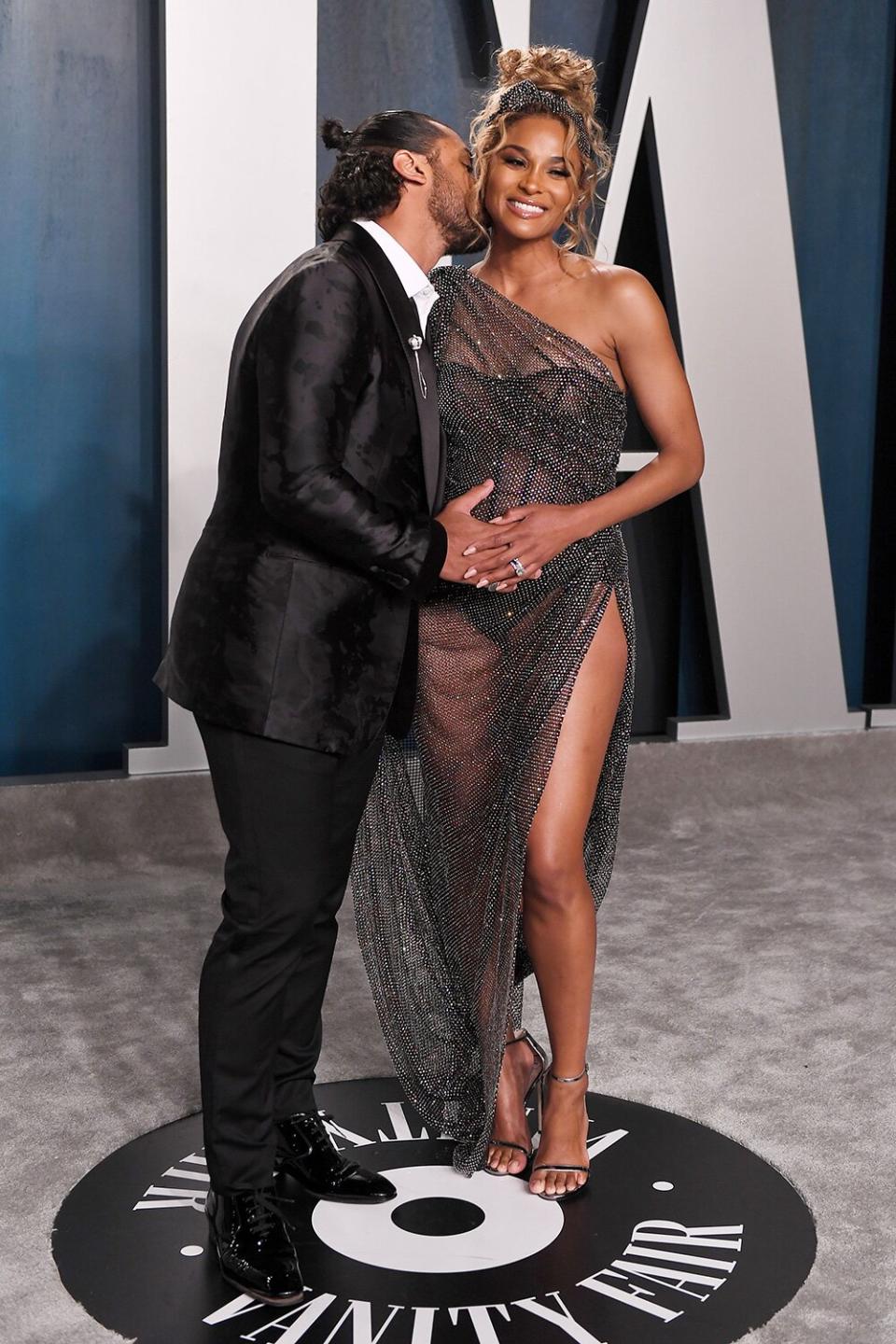 Bumpin' along! Russell Wilson and Ciara show some adorable PDA on their way into the Vanity Fair Oscar Party. 