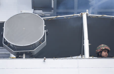 An Indian Navy personnel is seen looking out from warship INS Kolkata at Qingdao Port for the 70th anniversary celebrations of the founding of the Chinese People's Liberation Army Navy (PLAN), in Qingdao, China, April 21, 2019. REUTERS/Jason Lee